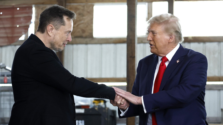 Elon Musk and Donald Trump shaking hands at rally