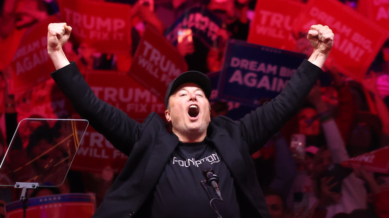 Elon Musk with arms aloft at Trump rally