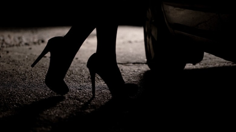 Woman in high heels opens car