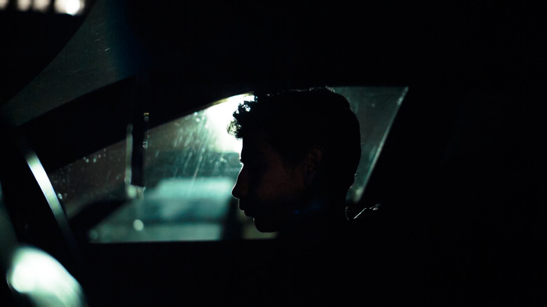 Profile silhouette of man in car 