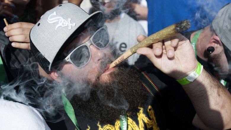 Man beard hat sunglasses smoking giant joint