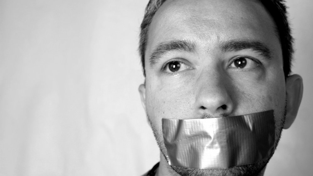 Man with tape over mouth.