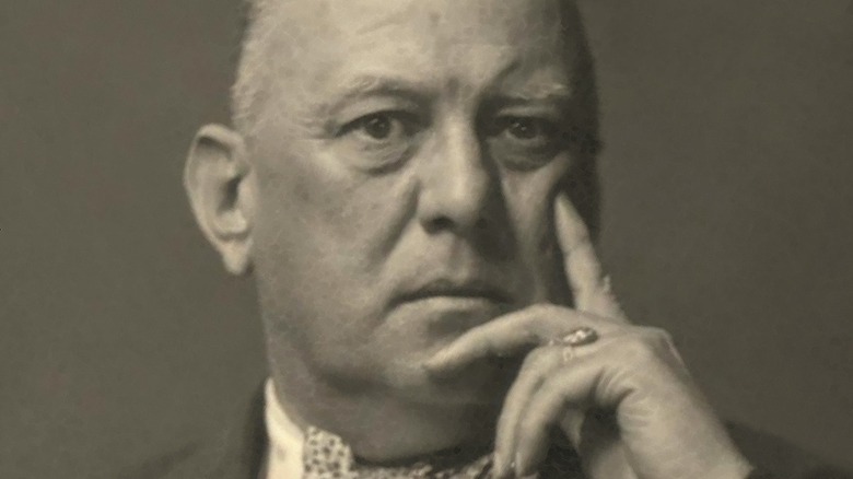 Aleister Crowley hand cheek