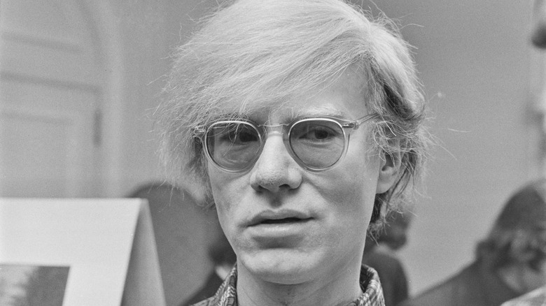 Andy Warhol smirks