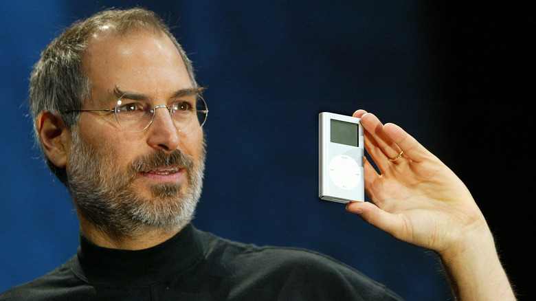 Steve Jobs holds an iPod