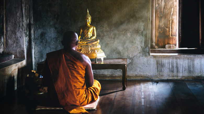 Buddha statue and monk