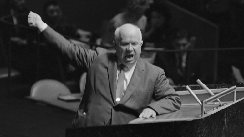 Khrushchev raised arm yelling podium