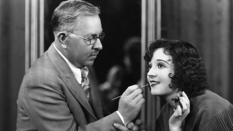 Max Factor putting makeup on Madge Bellamy