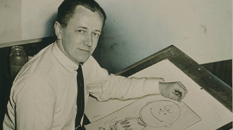 Cropped photo by Roger Higgins of Charles Schulz with a drawing of Charlie Brown