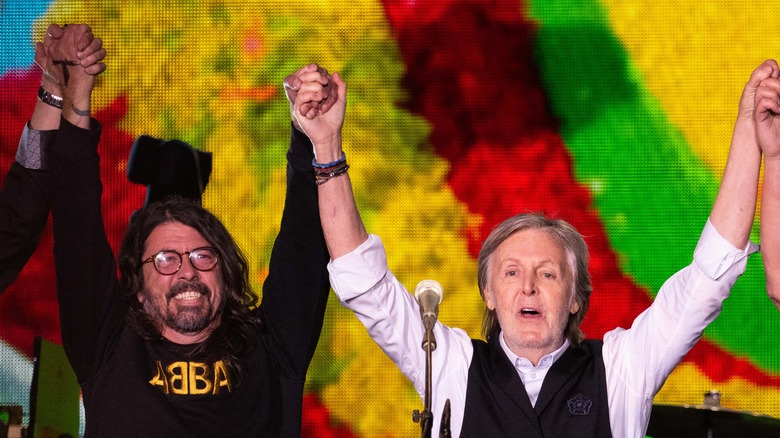 Dave Grohl and Paul McCartney hands raised