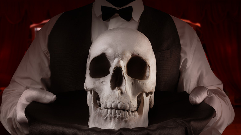 waiter bringing skull on a platter