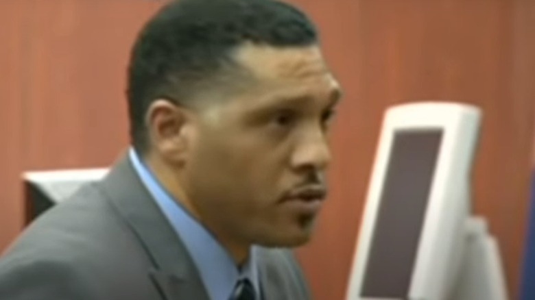 Mark Goudeau in a suit, speaking to jury in court