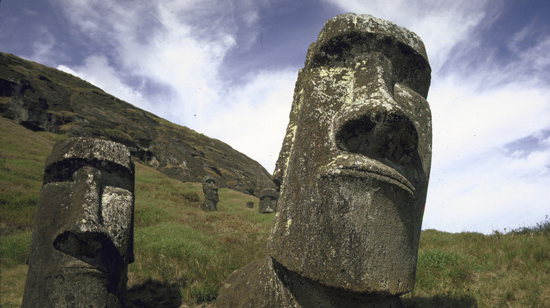 Easter Island heads in front of a hill