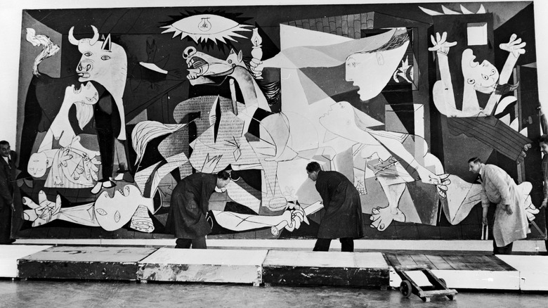 Pablo Picasso's Guernica being hung