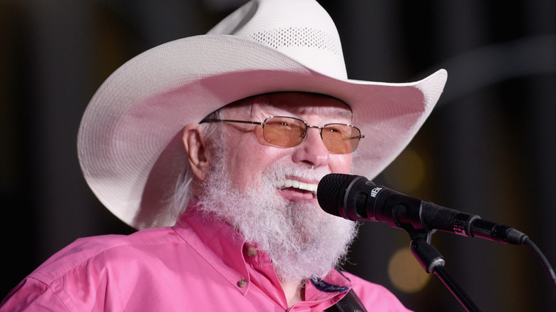 Charlie Daniels performing in a pink shirt in 2019