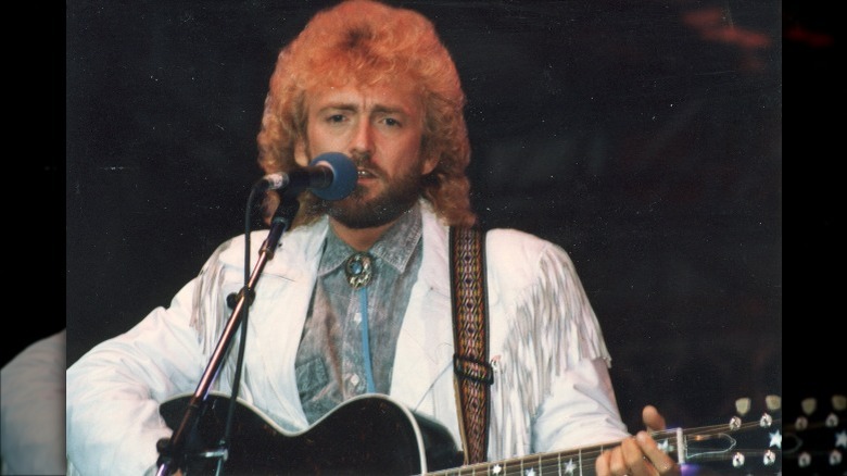 Keith Whitley performing in white fringed jacket