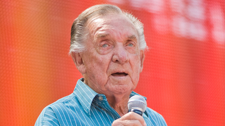 Ray Price performing with red background