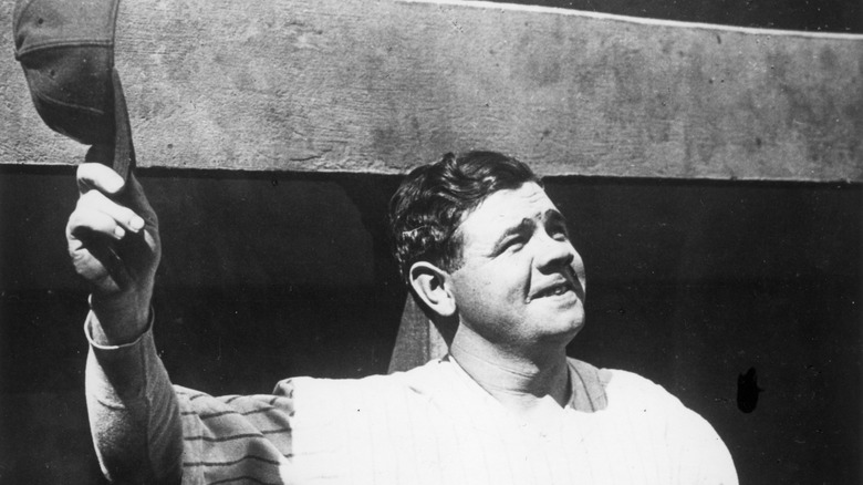 Babe Ruth waves his hat