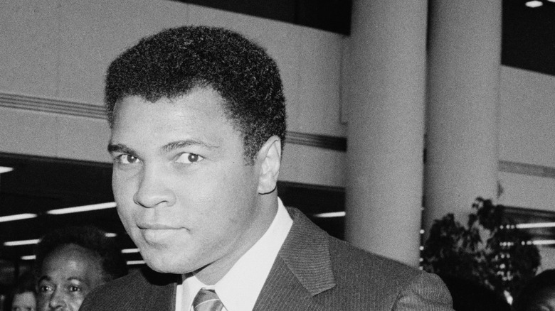 Muhammad Ali wearing suit and tie