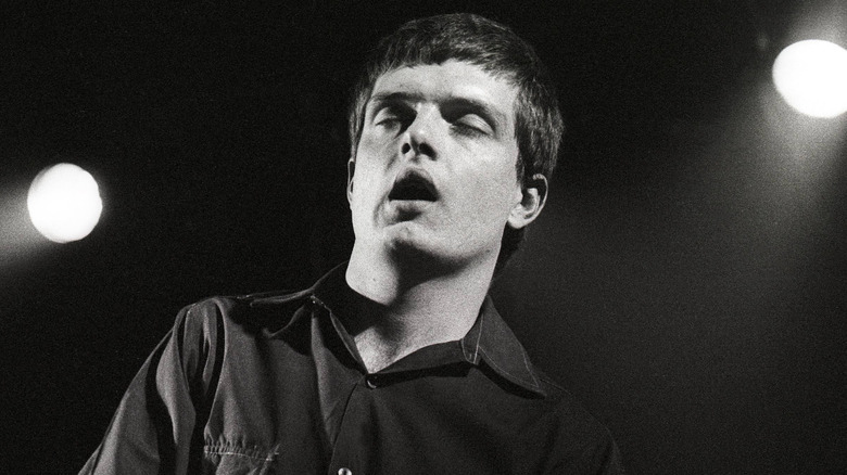 ian curtis eyes closed singing with joy division