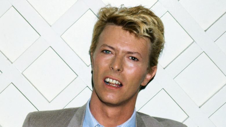 david bowie sneering in suit head cocked