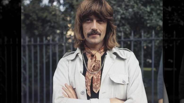 Jon Lord arms folded, smiling in a white jacket