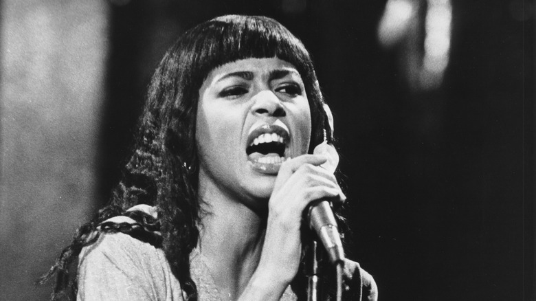 Irene Cara singing into a microphone