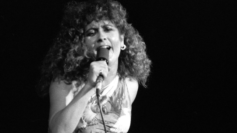 Teena Marie long curly hair singing microphone onstage