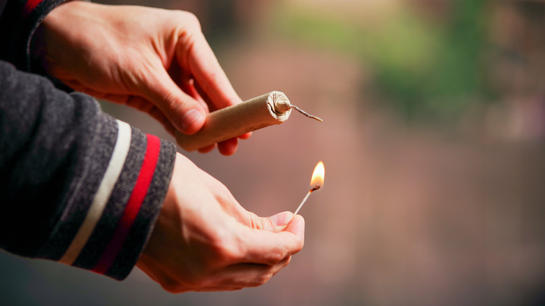 man lighting firework