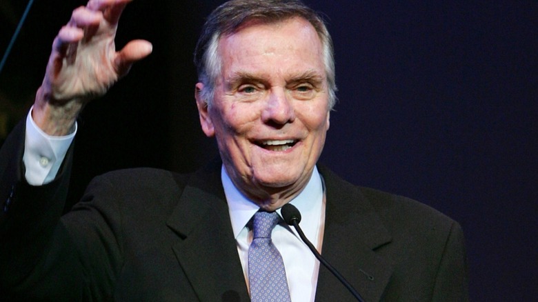 Peter Marshall smiling and waving hand