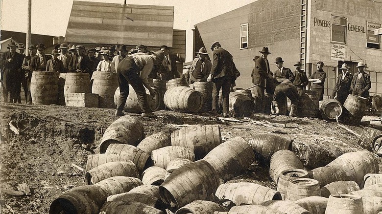 Prohibition raid with kegs in foreground