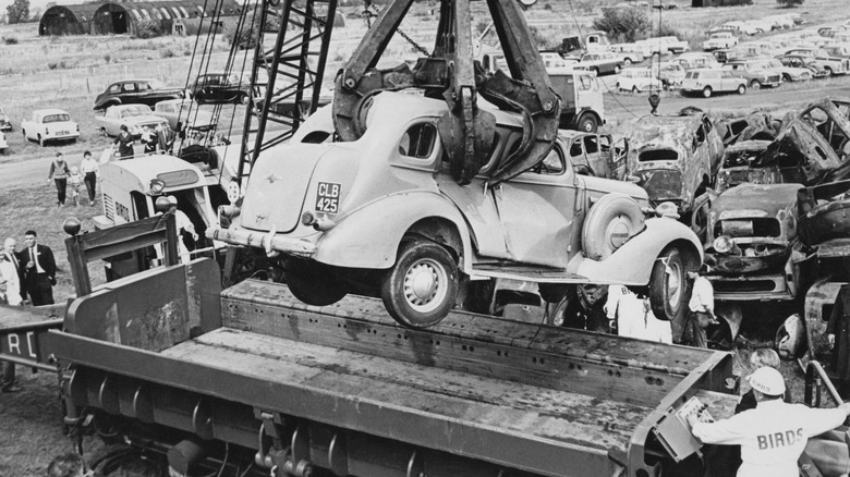 Old car being loaded into crusher