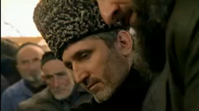 A still of Khozh-Ahmed Noukhayev in a furry hat