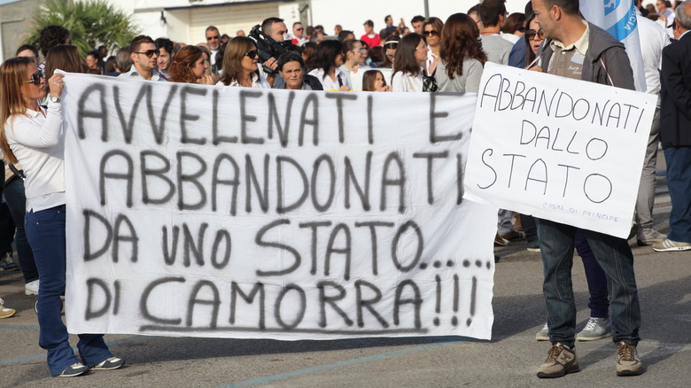 Protestors in Italy holding banners against the Camorra