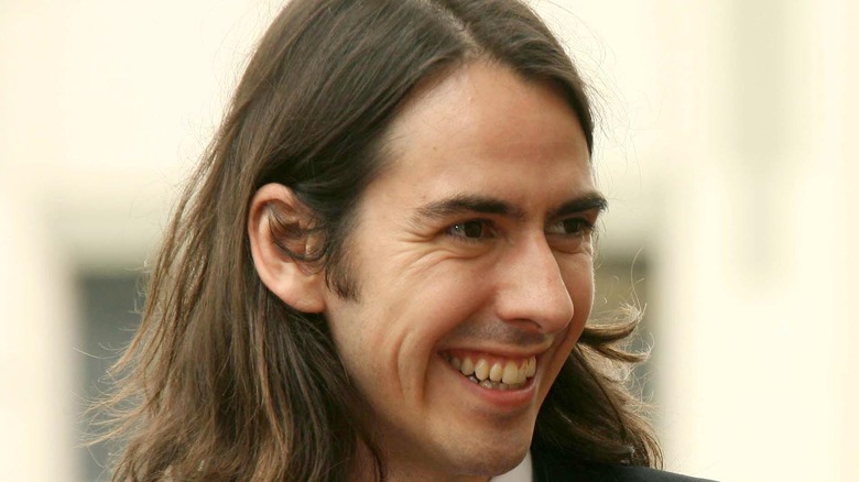 Dhani Harrison smiling to side