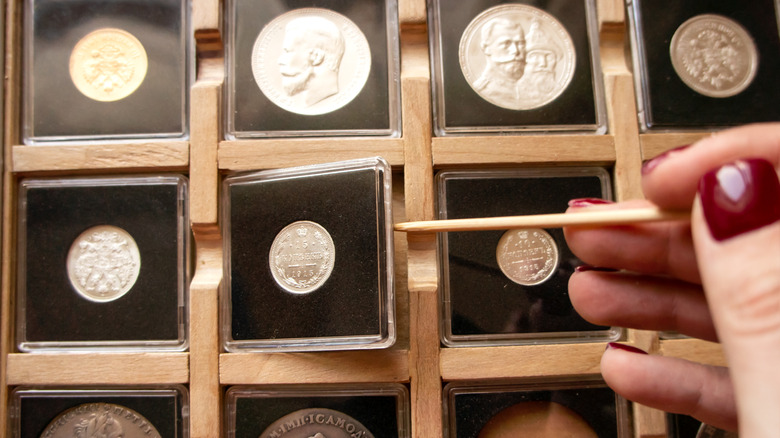 Person examining coins