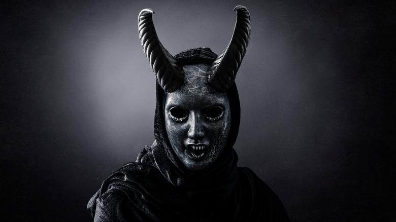 Person wearing devil mask