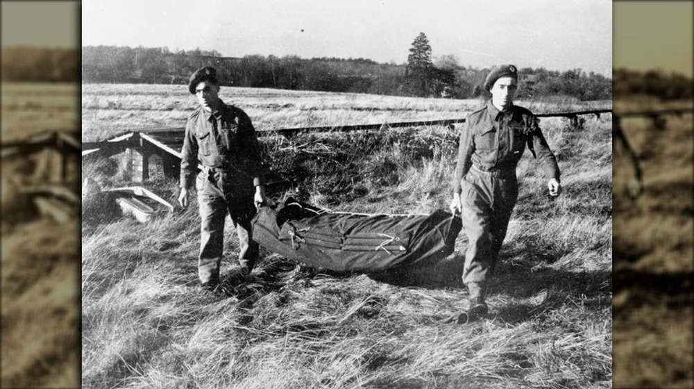 wwii soldiers carrying an inflatable