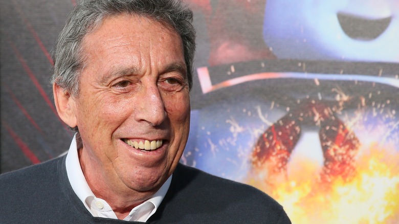 Ivan Reitman in front of a photo of the stay-puft marshmallow man