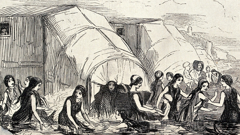illustration of women in sea near bathing machines