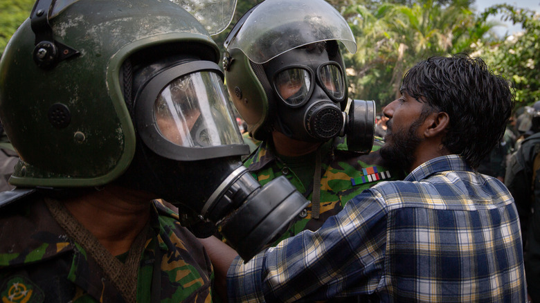 Sri Lankan police and demonstrator