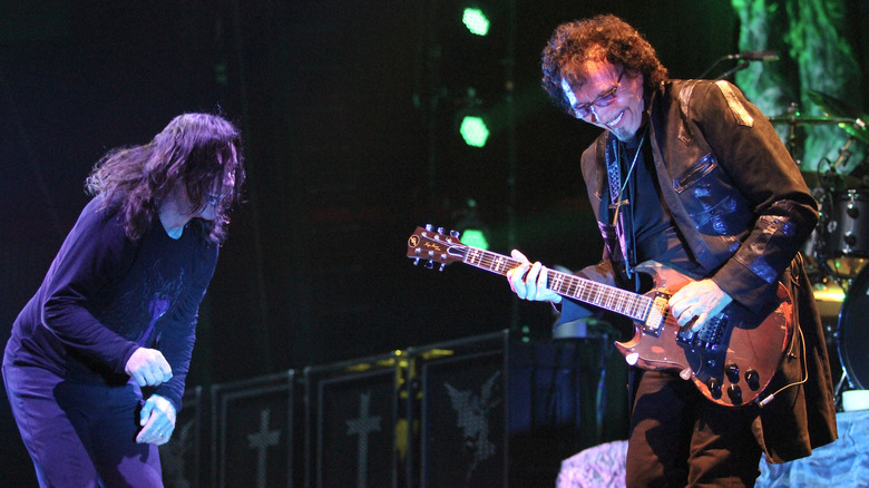 Ozzy and Tony smiling on stage