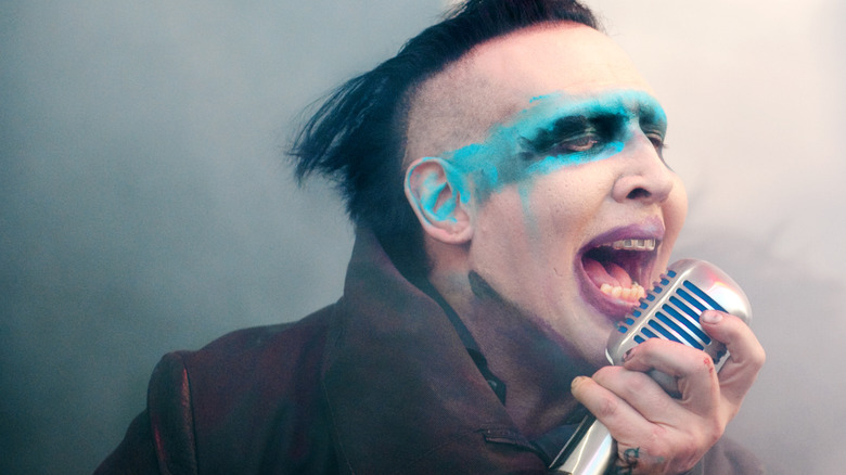 Marilyn Manson leans into mic