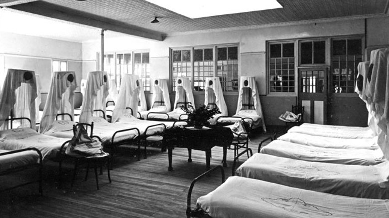 Beds lined up in asylum