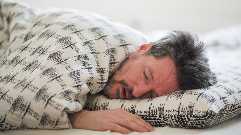 Man asleep in bed