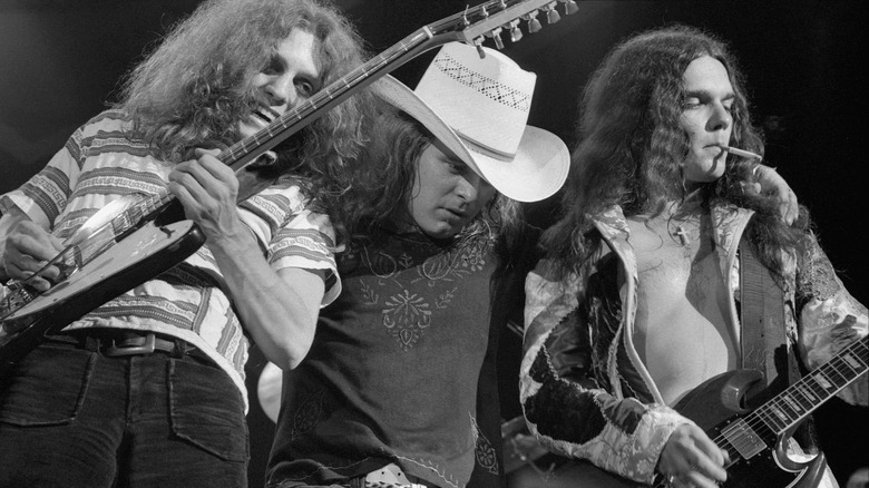 Allen Collins, Ronnie Van Zant, and Gary Rossington performing onstage