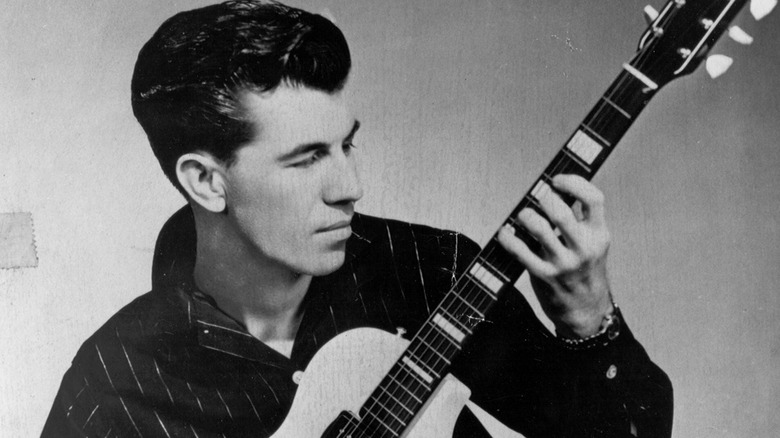 Link Wray posing with his guitar