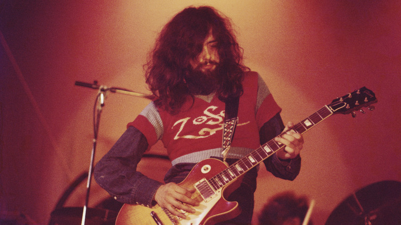 Jimmy Page playing guitar onstage