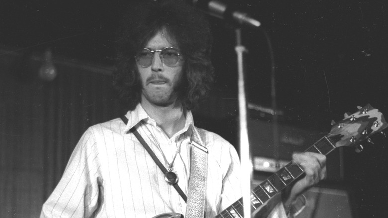 Eric Clapton looking serious while playing guitar