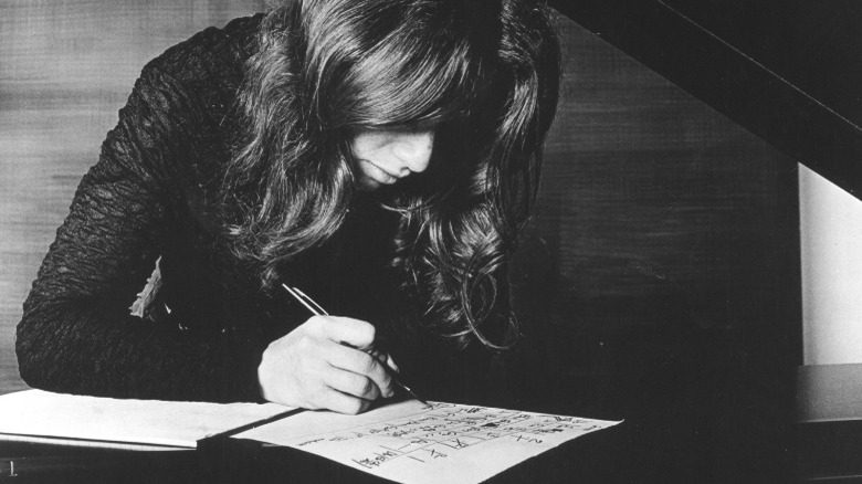 Carole King writing at piano 1970s